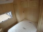 This image shows the master bedroom area of a motorhome constructed by us. Walls and cabinets in Canadian Maple with the bed itself custom made along with a special made mattress. A truly interesting build.